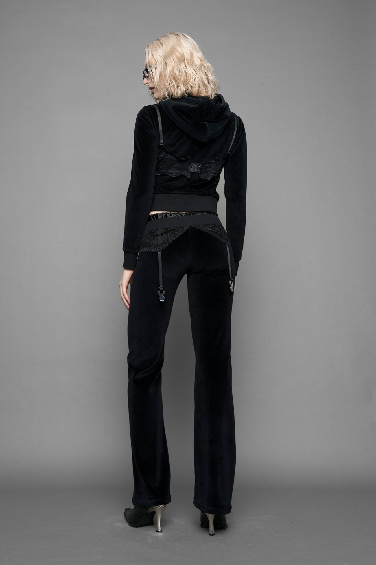 model is wearing a black velvet cropped zip-up hoodie with a black lace bralette and a Playboy branded key formed Zipper Pull 