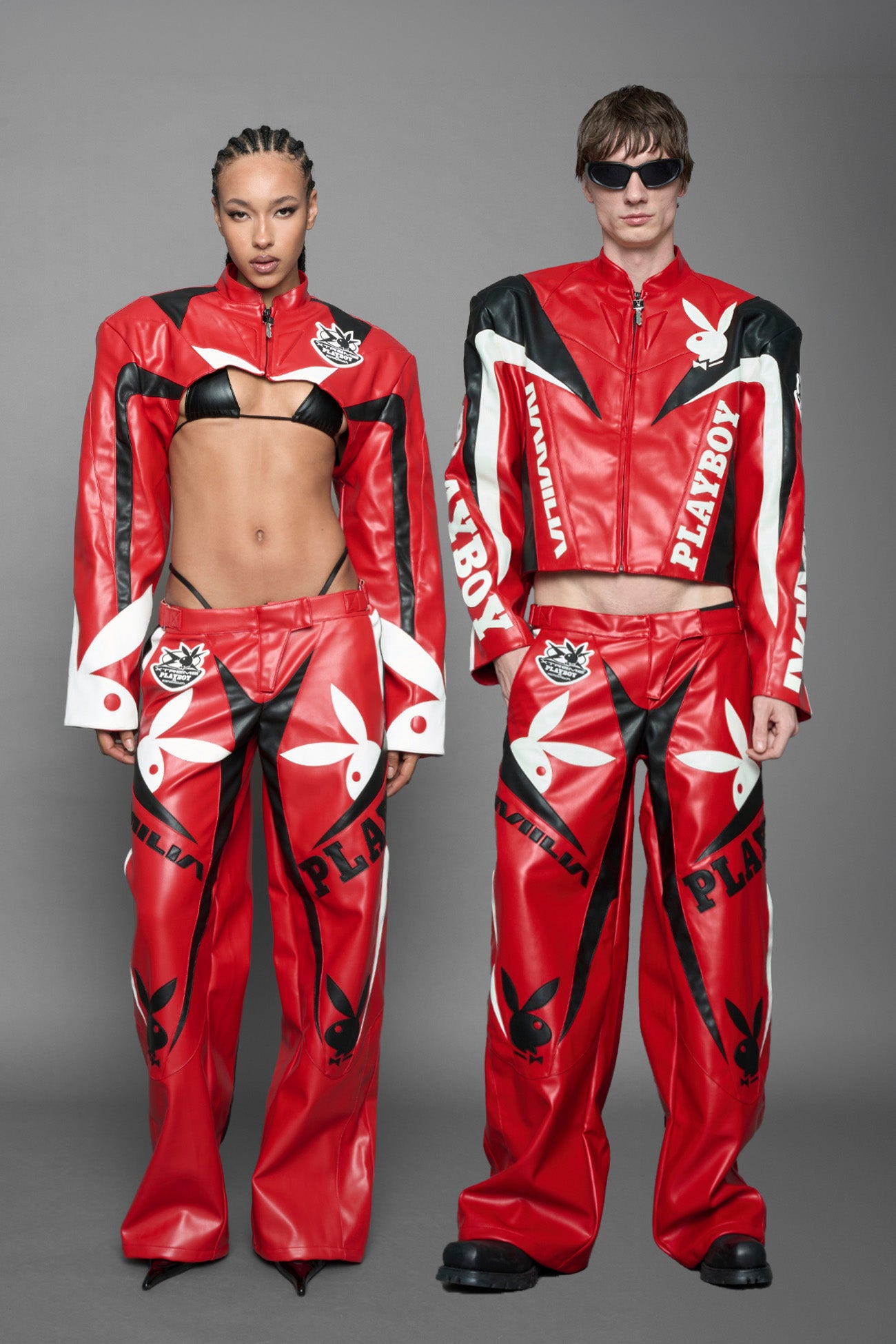 model is wearing red PU Leather pants with bold white Playboy bunny logos and white 'Namilia' Embroidery and rubber tag.