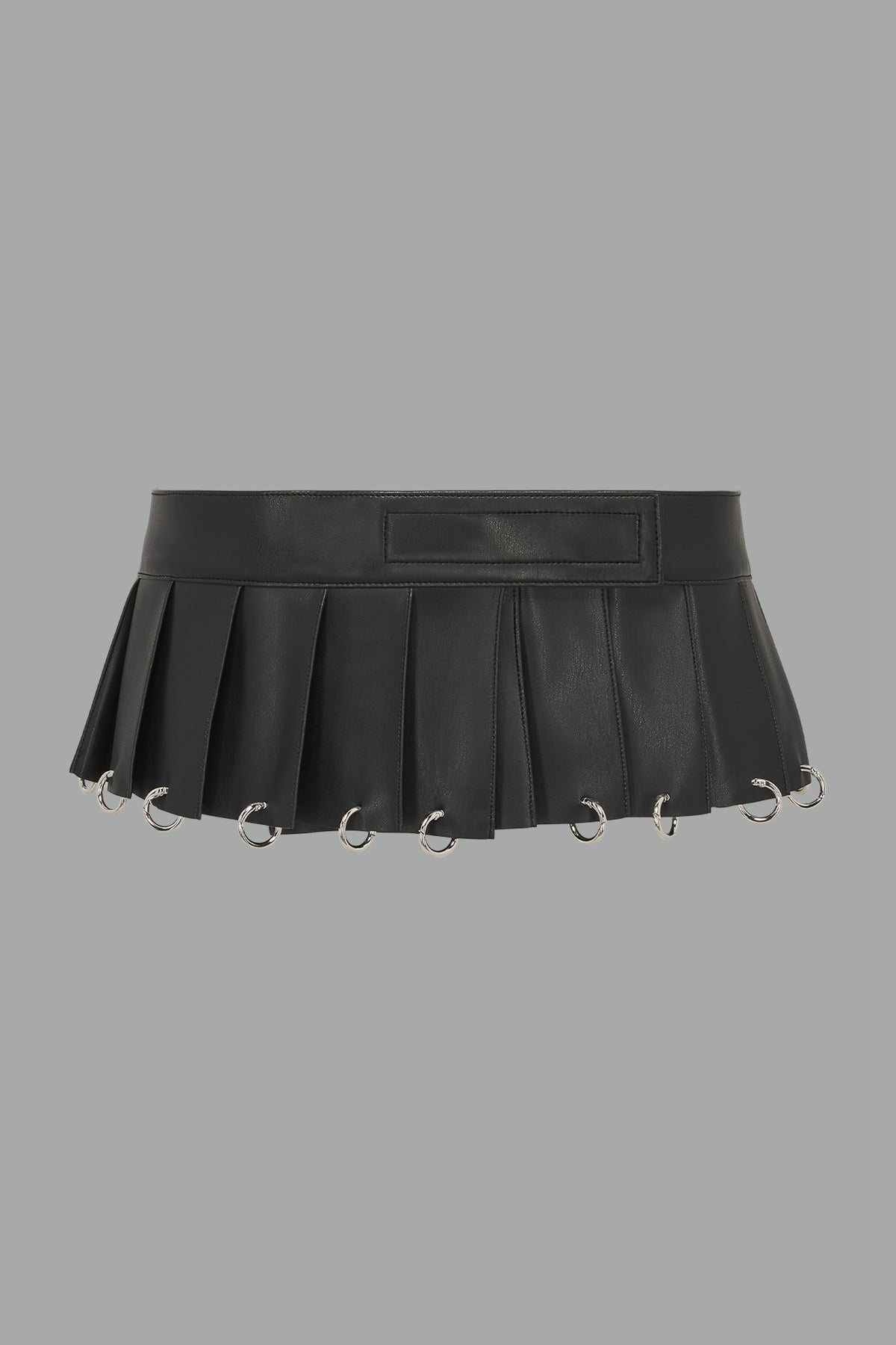 black Namilia Pleated Mini Skirt with ring piercing details on the hemline and velcro fold-over waistband closure.
