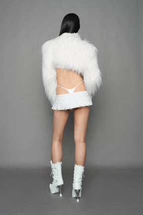 model wearing white vegan leather pleated mini skirt with ring details