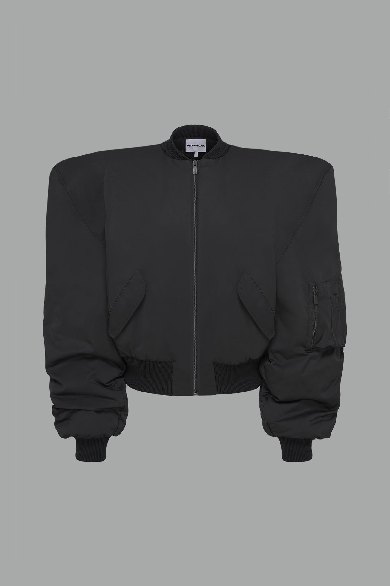 black oversize cropped nylon bomber with exaggerated shoulderpads and ruching on sleeves.