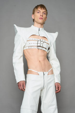 model wearing white vegan leather bolero jacket with spiked shoulder details