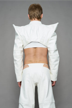 model wearing white vegan leather bolero jacket with spiked shoulder details