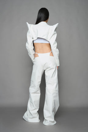 model wearing white vegan leather bolero jacket with spiked shoulder details