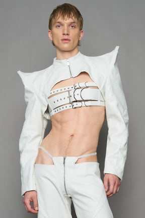 model wearing white vegan leather bolero jacket with spiked shoulder details