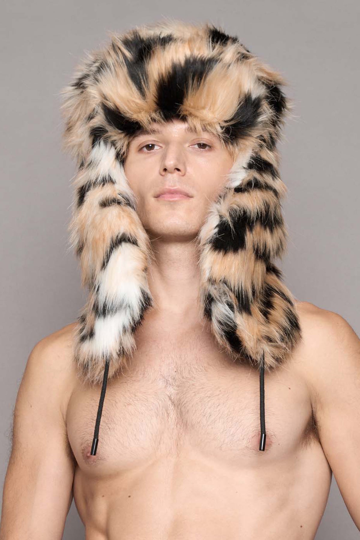 A male model wearing a tiger faux fur hooded hat, 